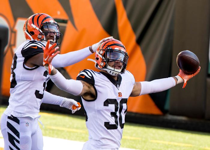 Cincinnati Bengals free safety Jessie Bates (30) celebrates with Cincinnati Bengals cornerback LeShaun Sims (38) after intercepting a pass in the end zone for a touchback in the first quarter of the NFL game between Cincinnati Bengals and Tennessee Titans on Sunday, Nov. 1, 2020, in Cincinnati. Cincinnati Bengals At Tennessee Titans